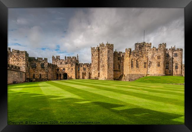 Majestic Alnwick Castle on a Moody Autumn Day Framed Print by Clive Ingram