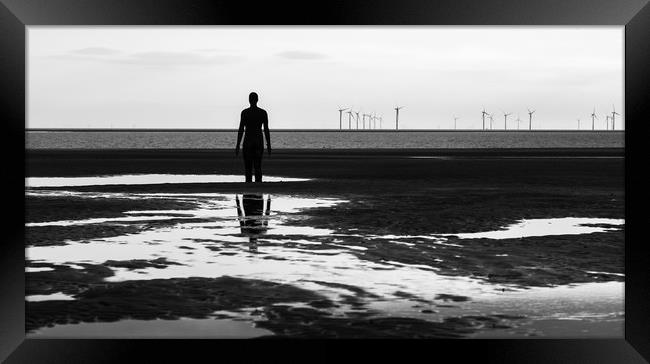 Iron Man looking out at a wind farm Framed Print by Jason Wells