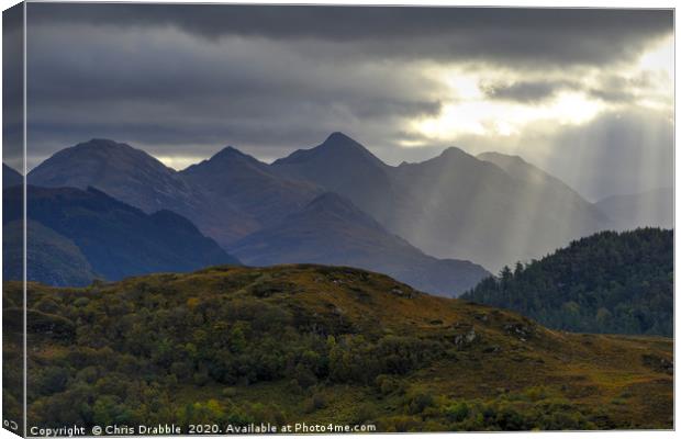 Crepuscular light rays over the Five Sisters Canvas Print by Chris Drabble