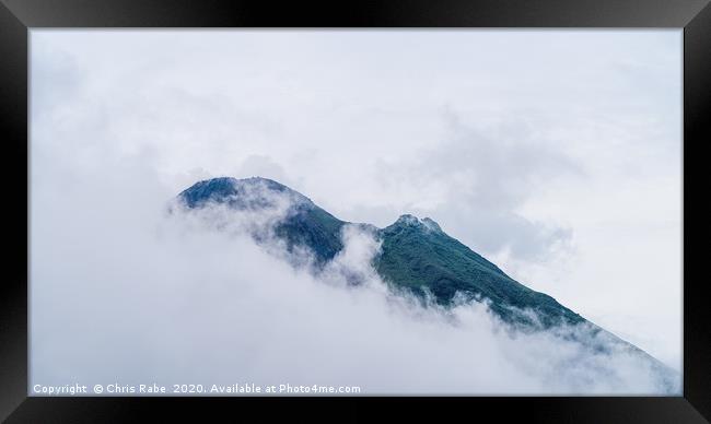 Arenal Volcano peaking through clouds Framed Print by Chris Rabe