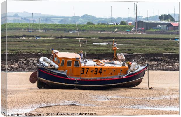 Lifeboat sitting on the mud flaps at Wells-Next-Se Canvas Print by Clive Wells
