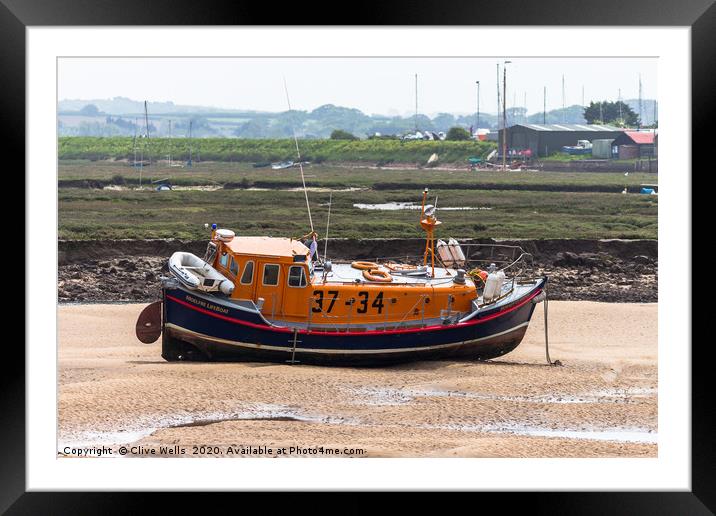 Lifeboat sitting on the mud flaps at Wells-Next-Se Framed Mounted Print by Clive Wells