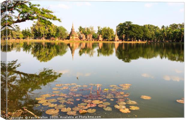 Stupas reflected in the lake  Canvas Print by Kevin Hellon
