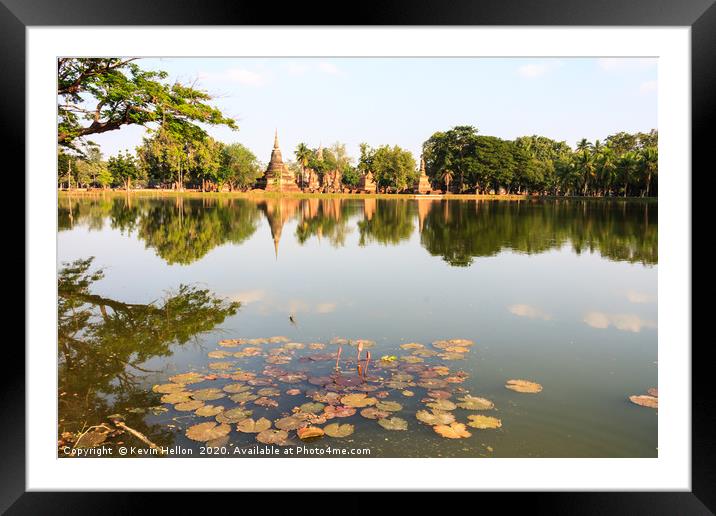 Stupas reflected in the lake  Framed Mounted Print by Kevin Hellon