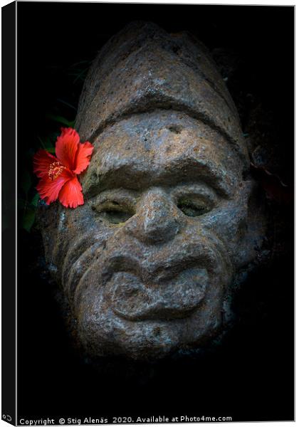 Balinesian stone face with a hibiscus flower Canvas Print by Stig Alenäs