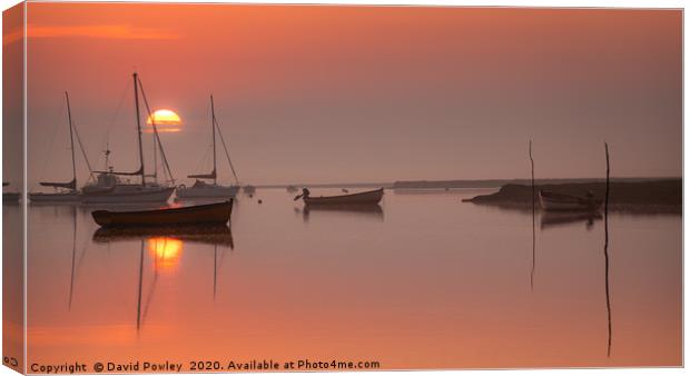 Rising sun at Brancaster Staithe Canvas Print by David Powley