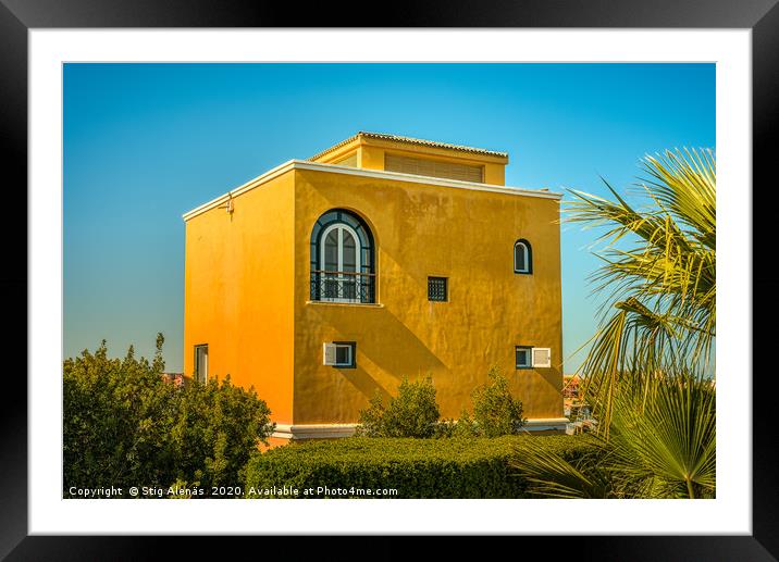 A yellow square house against blue sky  in a garde Framed Mounted Print by Stig Alenäs