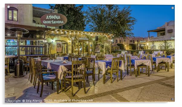 illuminated greek taverna with tables and chairs i Acrylic by Stig Alenäs
