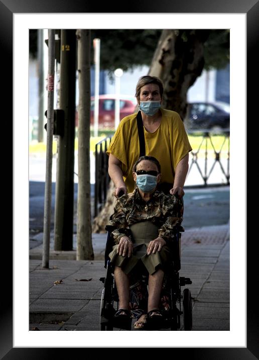 an invalid lady on a wheelchair is being pushed du Framed Mounted Print by Jose Manuel Espigares Garc