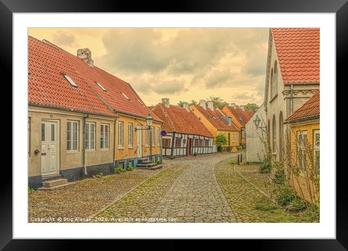 Ancient alleyway with old houses and hollyhocks Framed Mounted Print by Stig Alenäs