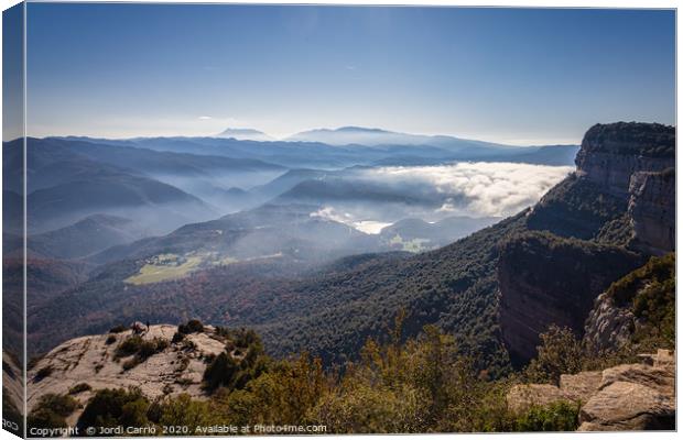 The fog dissipates in the mountains and valleys Canvas Print by Jordi Carrio