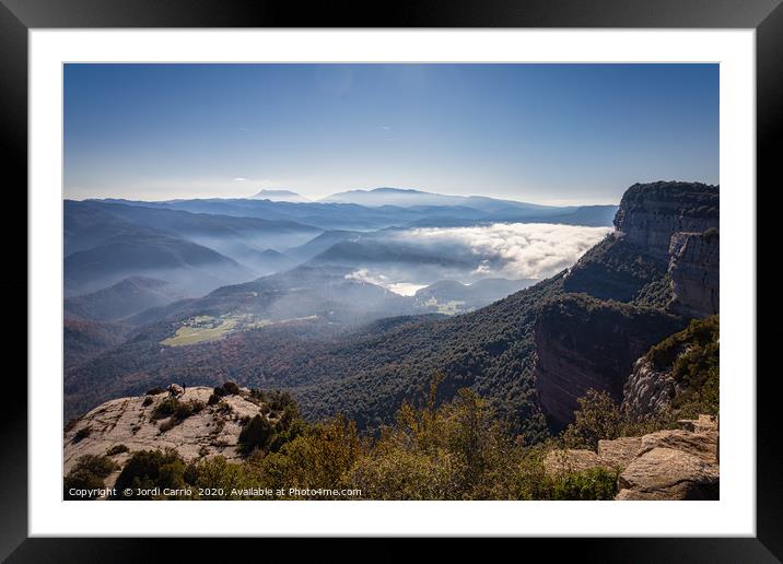 The fog dissipates in the mountains and valleys Framed Mounted Print by Jordi Carrio