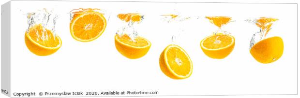 Orange halves splashing into water panorama shoot Canvas Print by Przemek Iciak