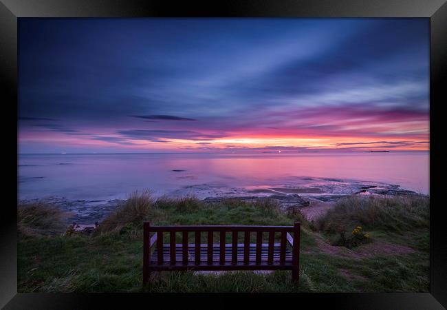 Bamburgh beach with a lone bench Framed Print by John Finney