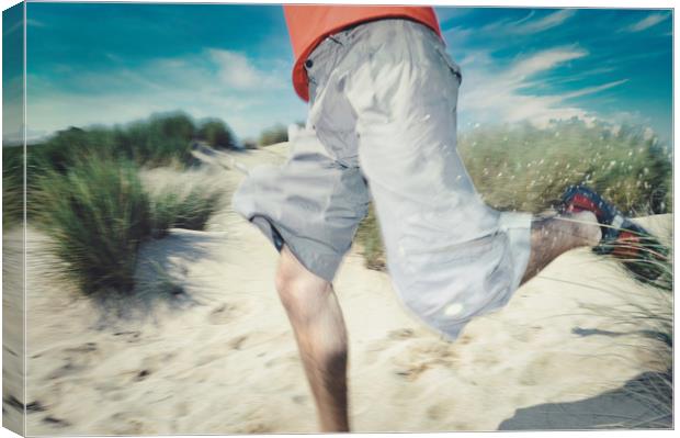blurry photo of man legs running through sand Canvas Print by federico stevanin