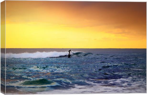  lone surfer rides the wave of the ocean at sunset Canvas Print by federico stevanin