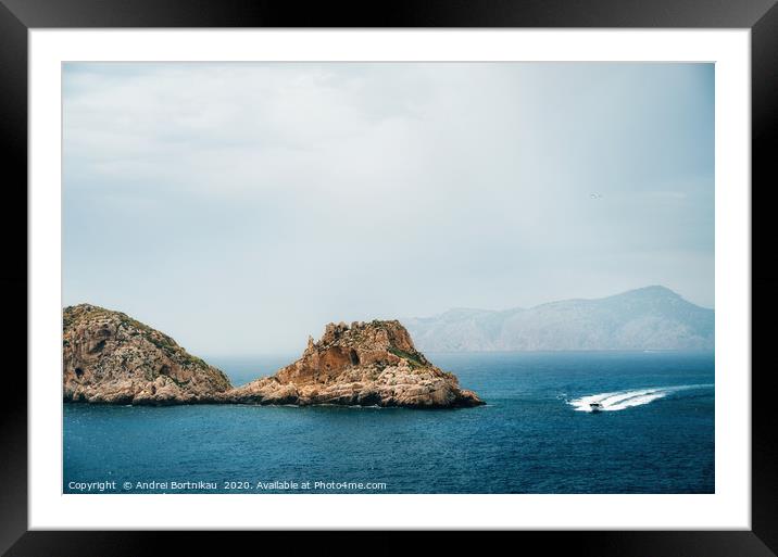 The yacht sails near the rocks Framed Mounted Print by Andrei Bortnikau