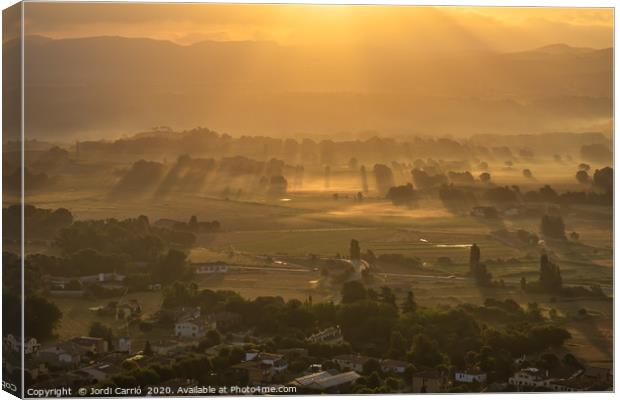 Sunbeams and haze in the valley Canvas Print by Jordi Carrio