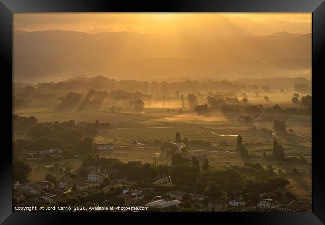 Sunbeams and haze in the valley Framed Print by Jordi Carrio