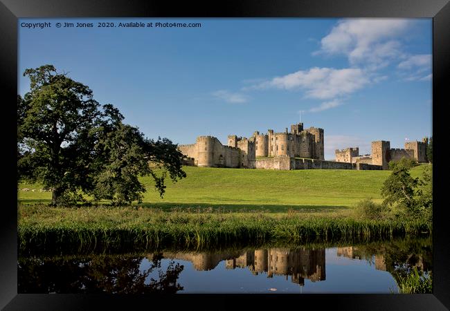 Alnwick Castle reflected in the River Aln Framed Print by Jim Jones