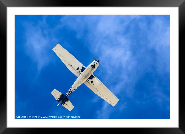 Small Aeroplane with blue sky and light clouds Framed Mounted Print by Miro V