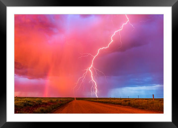 Monsoon sunset lightning with a rainbow Framed Mounted Print by John Finney