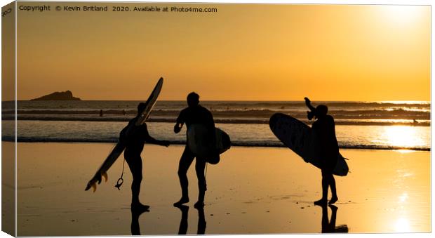 Surfers at sunset Canvas Print by Kevin Britland