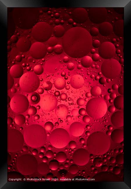 Red 'moon craters' ball Framed Print by PhotoStock Israel