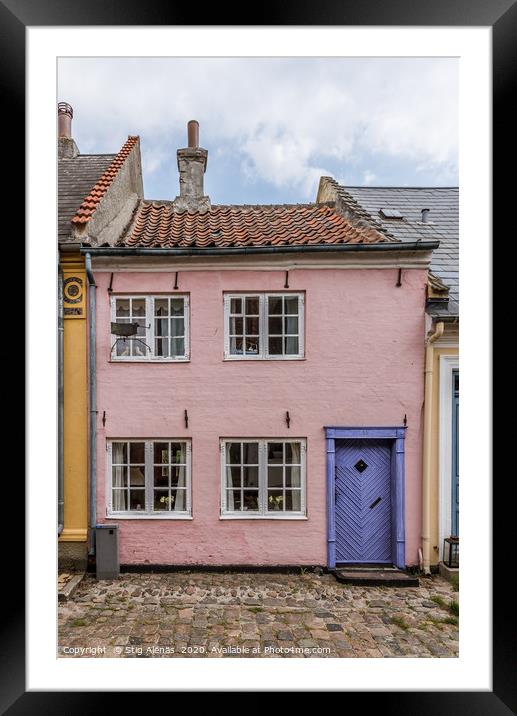 a small house in pink with a blue door on a cobble Framed Mounted Print by Stig Alenäs