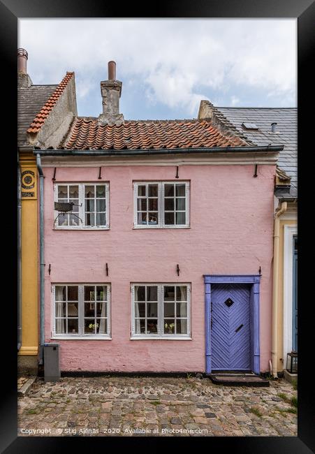 a small house in pink with a blue door on a cobble Framed Print by Stig Alenäs
