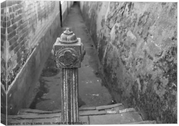Metal post restricting alleyway access Canvas Print by Chris Yaxley