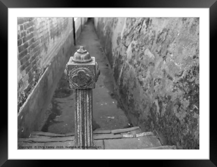 Metal post restricting alleyway access Framed Mounted Print by Chris Yaxley