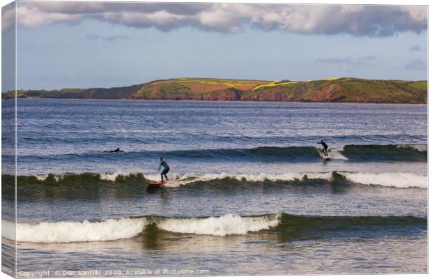 Surfing at Manorbier in Pembrokeshire Canvas Print by Dan Santillo