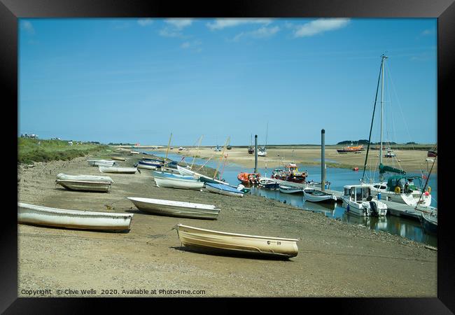 Rowing boats at low tide seen at Wells-Next-Sea in Framed Print by Clive Wells
