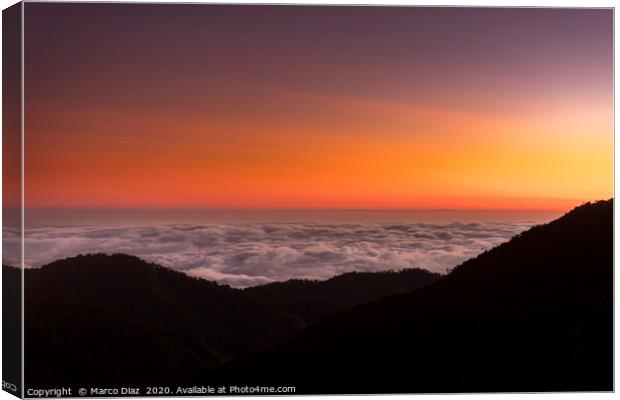 Sunset and sea of clouds Canvas Print by Marco Diaz