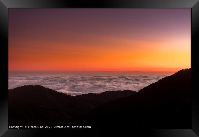 Sunset and sea of clouds Framed Print by Marco Diaz