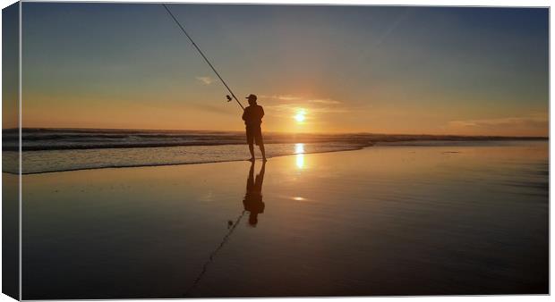 Fisherman on wide sand beach at sunset 1 Canvas Print by Hanif Setiawan