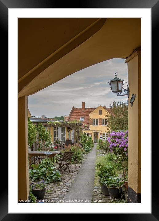 A gateway and a path through a grden full of flowe Framed Mounted Print by Stig Alenäs
