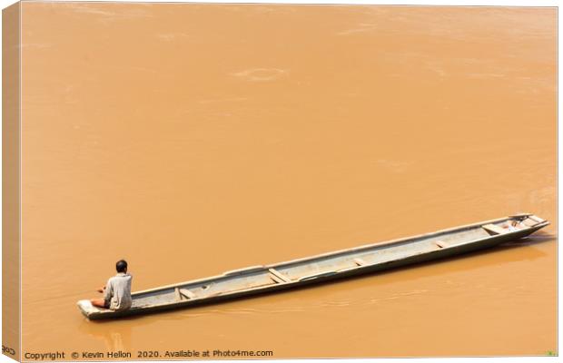 Man in boat on the Mekhong River  Canvas Print by Kevin Hellon
