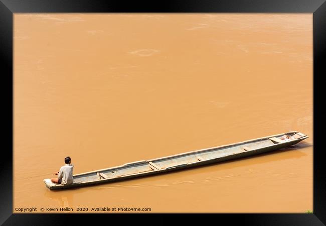 Man in boat on the Mekhong River  Framed Print by Kevin Hellon