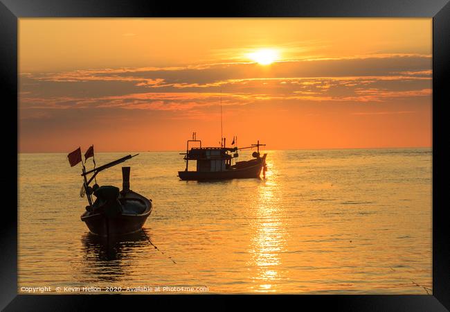 Silhouettes of boats on Bang Tao Beach Framed Print by Kevin Hellon