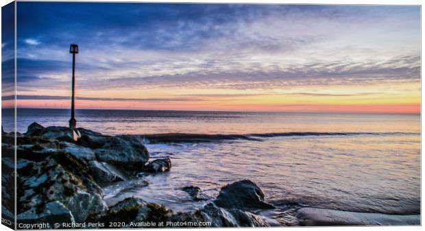 Sunrise over rocks Canvas Print by Richard Perks