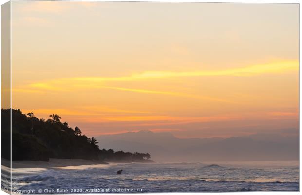 Surfer at sunrise Canvas Print by Chris Rabe