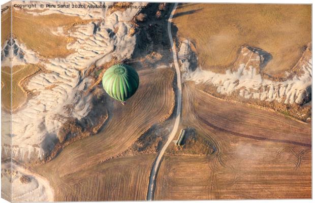 Air balloon landing over grow fields Canvas Print by Pere Sanz