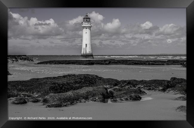 lighthouse in the clouds Framed Print by Richard Perks