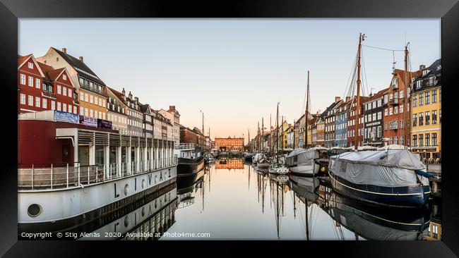 Sunrise over the calm water at Nyhavn harbor  in C Framed Print by Stig Alenäs