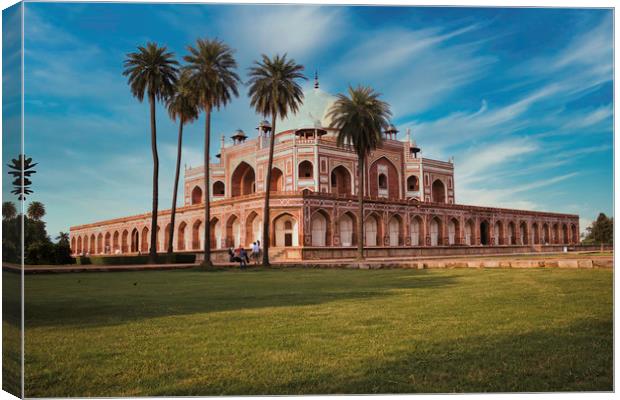 Humayun tomb behind palm tree and dramatic blue sk Canvas Print by Arpan Bhatia
