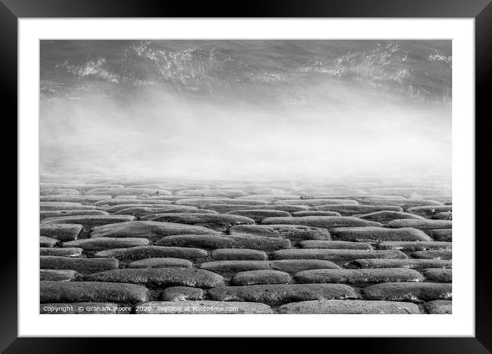 Wave splashes on cobbles monochrome Framed Mounted Print by Graham Moore