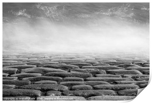 Wave splashes on cobbles monochrome Print by Graham Moore