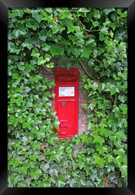 A red Victorian post box in an ivy covered wall Framed Print by John Keates
